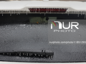 Ice covers the rear window of a vehicle as freezing rain causes surfaces to be coated with a sheet of ice in Toronto, Ontario, Canada, on De...