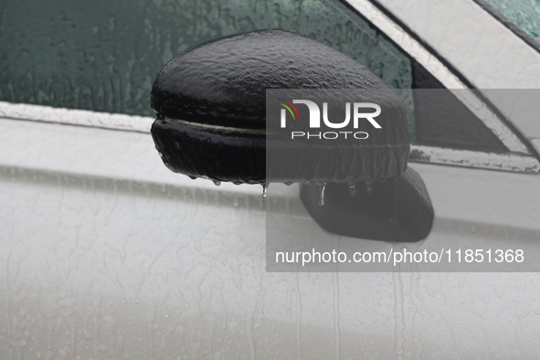 A thin sheet of ice covers a vehicle as freezing rain causes surfaces to be coated with a sheet of ice in Toronto, Ontario, Canada, on Decem...