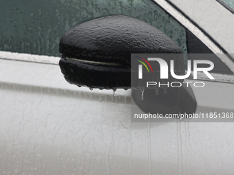 A thin sheet of ice covers a vehicle as freezing rain causes surfaces to be coated with a sheet of ice in Toronto, Ontario, Canada, on Decem...