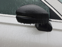 A thin sheet of ice covers a vehicle as freezing rain causes surfaces to be coated with a sheet of ice in Toronto, Ontario, Canada, on Decem...