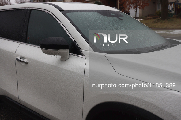 Ice covers a vehicle as freezing rain causes surfaces to be coated with a sheet of ice in Toronto, Ontario, Canada, on December 09, 2024. 