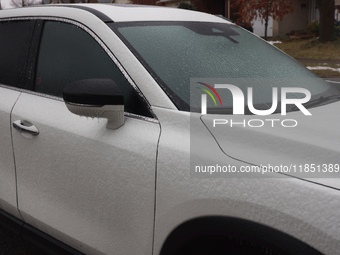 Ice covers a vehicle as freezing rain causes surfaces to be coated with a sheet of ice in Toronto, Ontario, Canada, on December 09, 2024. (