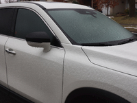 Ice covers a vehicle as freezing rain causes surfaces to be coated with a sheet of ice in Toronto, Ontario, Canada, on December 09, 2024. (