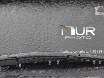 Ice covers the windshield of a vehicle as freezing rain causes surfaces to be coated with a sheet of ice in Toronto, Ontario, Canada, on Dec...