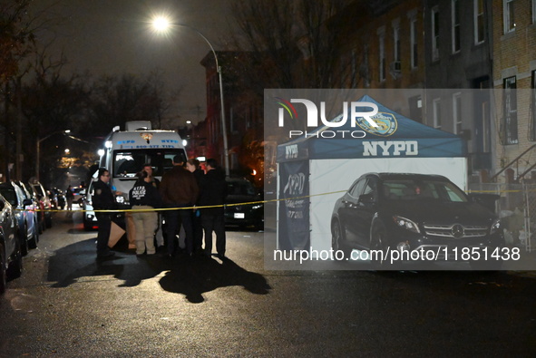 The NYPD Crime Scene Unit places evidence markers at the scene where a 28-year-old man is killed after being shot in the head in the East Fl...