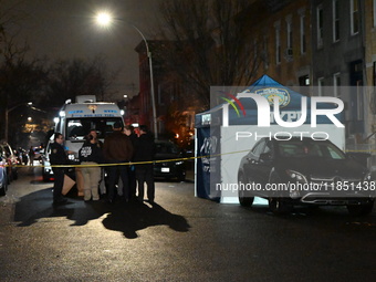 The NYPD Crime Scene Unit places evidence markers at the scene where a 28-year-old man is killed after being shot in the head in the East Fl...