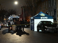 The NYPD Crime Scene Unit places evidence markers at the scene where a 28-year-old man is killed after being shot in the head in the East Fl...