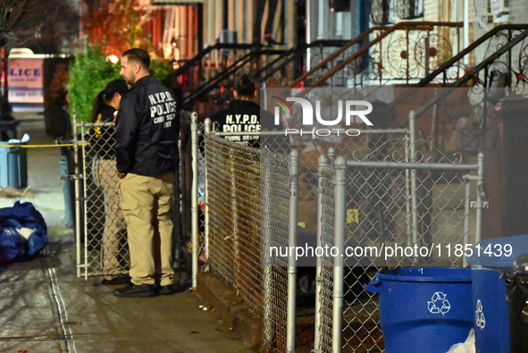 The NYPD Crime Scene Unit places evidence markers at the scene where a 28-year-old man is killed after being shot in the head in the East Fl...