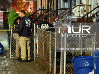 The NYPD Crime Scene Unit places evidence markers at the scene where a 28-year-old man is killed after being shot in the head in the East Fl...