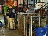 The NYPD Crime Scene Unit places evidence markers at the scene where a 28-year-old man is killed after being shot in the head in the East Fl...