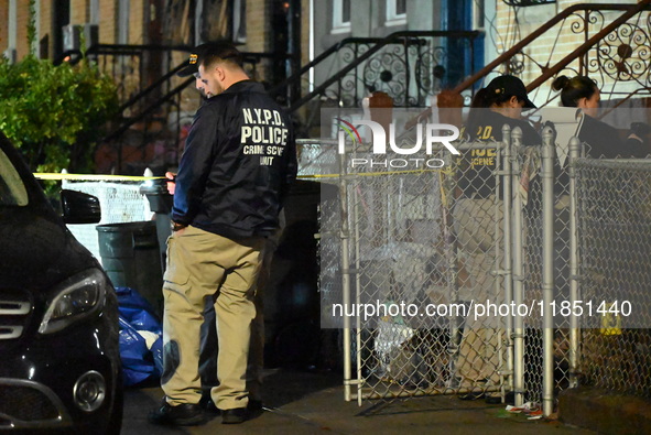 The NYPD Crime Scene Unit places evidence markers at the scene where a 28-year-old man is killed after being shot in the head in the East Fl...