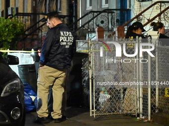 The NYPD Crime Scene Unit places evidence markers at the scene where a 28-year-old man is killed after being shot in the head in the East Fl...