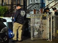 The NYPD Crime Scene Unit places evidence markers at the scene where a 28-year-old man is killed after being shot in the head in the East Fl...