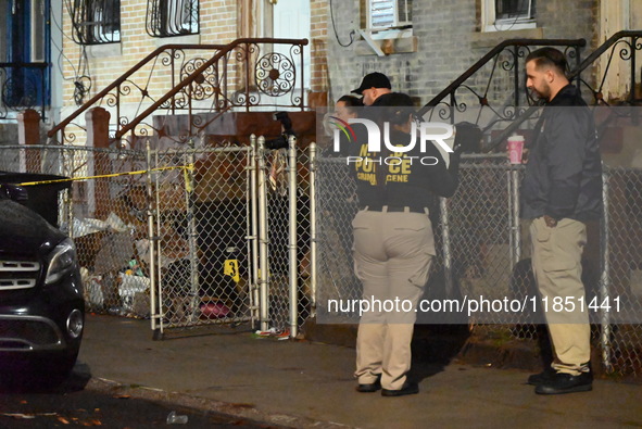 The NYPD Crime Scene Unit places evidence markers at the scene where a 28-year-old man is killed after being shot in the head in the East Fl...