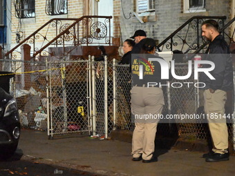 The NYPD Crime Scene Unit places evidence markers at the scene where a 28-year-old man is killed after being shot in the head in the East Fl...