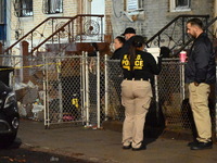 The NYPD Crime Scene Unit places evidence markers at the scene where a 28-year-old man is killed after being shot in the head in the East Fl...