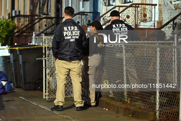 The NYPD Crime Scene Unit places evidence markers at the scene where a 28-year-old man is killed after being shot in the head in the East Fl...