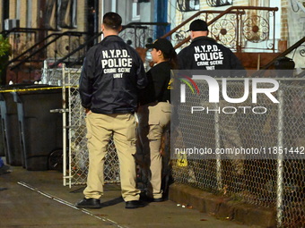 The NYPD Crime Scene Unit places evidence markers at the scene where a 28-year-old man is killed after being shot in the head in the East Fl...