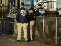 The NYPD Crime Scene Unit places evidence markers at the scene where a 28-year-old man is killed after being shot in the head in the East Fl...