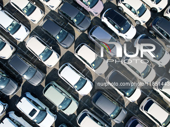 An aerial view shows various types of cars waiting to be loaded at a railway freight yard in Hangzhou, China, on December 9, 2024. (