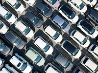 An aerial view shows various types of cars waiting to be loaded at a railway freight yard in Hangzhou, China, on December 9, 2024. (