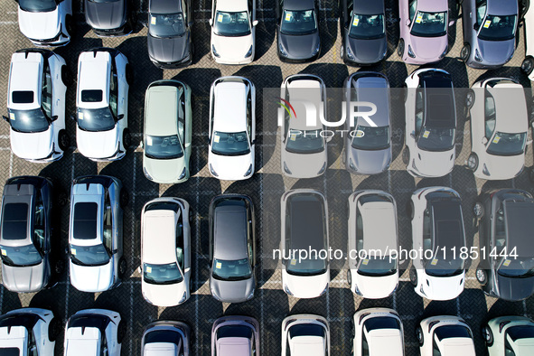 An aerial view shows various types of cars waiting to be loaded at a railway freight yard in Hangzhou, China, on December 9, 2024. 