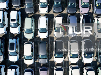 An aerial view shows various types of cars waiting to be loaded at a railway freight yard in Hangzhou, China, on December 9, 2024. (