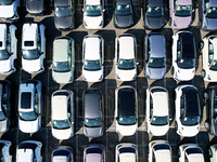 An aerial view shows various types of cars waiting to be loaded at a railway freight yard in Hangzhou, China, on December 9, 2024. (