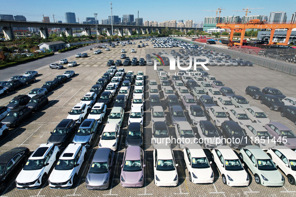 An aerial view shows various types of cars waiting to be loaded at a railway freight yard in Hangzhou, China, on December 9, 2024. 