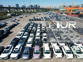 An aerial view shows various types of cars waiting to be loaded at a railway freight yard in Hangzhou, China, on December 9, 2024. (