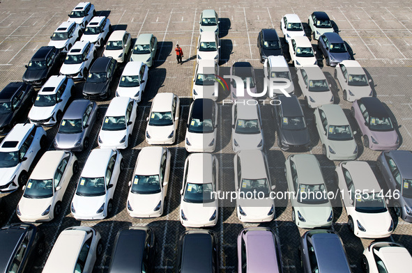 An aerial view shows various types of cars waiting to be loaded at a railway freight yard in Hangzhou, China, on December 9, 2024. 