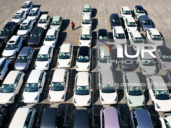 An aerial view shows various types of cars waiting to be loaded at a railway freight yard in Hangzhou, China, on December 9, 2024. (