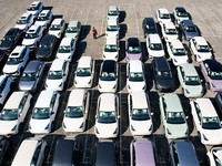 An aerial view shows various types of cars waiting to be loaded at a railway freight yard in Hangzhou, China, on December 9, 2024. (