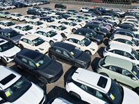 An aerial view shows various types of cars waiting to be loaded at a railway freight yard in Hangzhou, China, on December 9, 2024. (