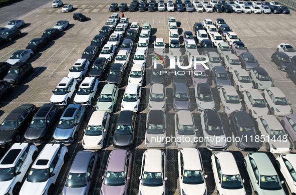 An aerial view shows various types of cars waiting to be loaded at a railway freight yard in Hangzhou, China, on December 9, 2024. 