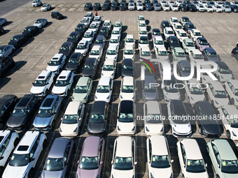 An aerial view shows various types of cars waiting to be loaded at a railway freight yard in Hangzhou, China, on December 9, 2024. (