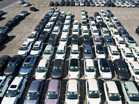 An aerial view shows various types of cars waiting to be loaded at a railway freight yard in Hangzhou, China, on December 9, 2024. (