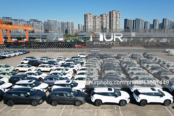 An aerial view shows various types of cars waiting to be loaded at a railway freight yard in Hangzhou, China, on December 9, 2024. 