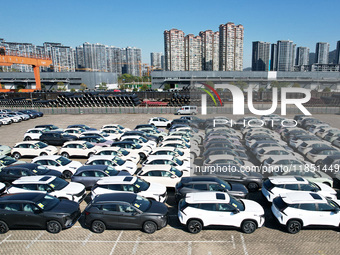 An aerial view shows various types of cars waiting to be loaded at a railway freight yard in Hangzhou, China, on December 9, 2024. (