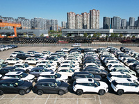 An aerial view shows various types of cars waiting to be loaded at a railway freight yard in Hangzhou, China, on December 9, 2024. (