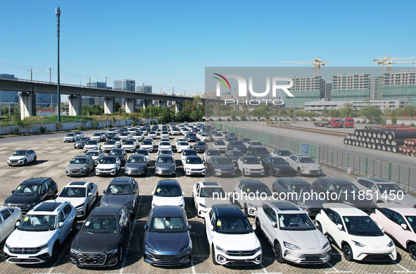 An aerial view shows various types of cars waiting to be loaded at a railway freight yard in Hangzhou, China, on December 9, 2024. 