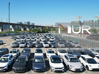 An aerial view shows various types of cars waiting to be loaded at a railway freight yard in Hangzhou, China, on December 9, 2024. (