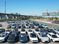 An aerial view shows various types of cars waiting to be loaded at a railway freight yard in Hangzhou, China, on December 9, 2024. (