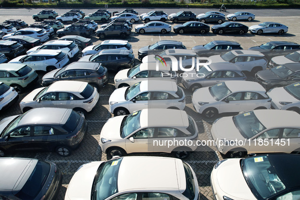 An aerial view shows various types of cars waiting to be loaded at a railway freight yard in Hangzhou, China, on December 9, 2024. 