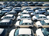 An aerial view shows various types of cars waiting to be loaded at a railway freight yard in Hangzhou, China, on December 9, 2024. (