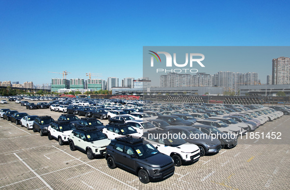 An aerial view shows various types of cars waiting to be loaded at a railway freight yard in Hangzhou, China, on December 9, 2024. 