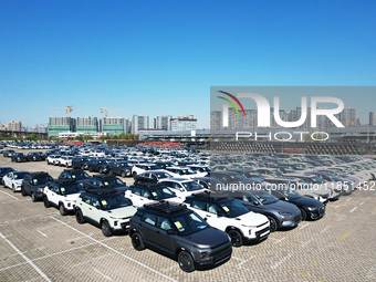 An aerial view shows various types of cars waiting to be loaded at a railway freight yard in Hangzhou, China, on December 9, 2024. (