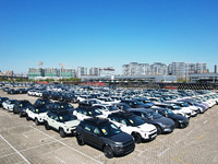 An aerial view shows various types of cars waiting to be loaded at a railway freight yard in Hangzhou, China, on December 9, 2024. (