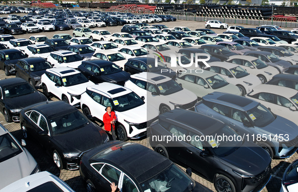 An aerial view shows various types of cars waiting to be loaded at a railway freight yard in Hangzhou, China, on December 9, 2024. 