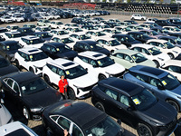 An aerial view shows various types of cars waiting to be loaded at a railway freight yard in Hangzhou, China, on December 9, 2024. (